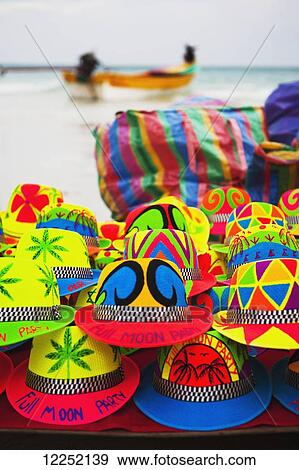 Colourful souvenir hats for sale on the beach; Ko Phangan, Thailand View Large Photo Image Stock Photo - Colourful souvenir hats for sale on the beach; Ko Phangan, Thailand. Fotosearch
