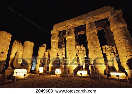 Stock Photo - Columns And Monumental Statues In The Courtyard Of Ramses Ii Of The Luxor Temple At Night, Luxor, Qina, Egypt. Fotosearch