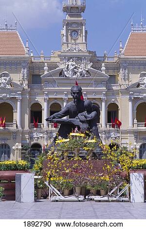 Stock Image - Communist Party Headquarters With Ho Chi Minh Statue. Fotosearch