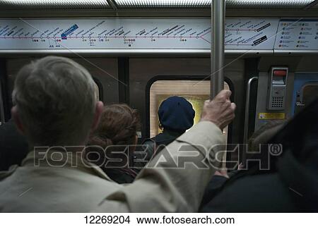 Commuters on the subway train; Paris, France View Large Photo Image Picture - Commuters on the subway train; Paris, France. Fotosearch