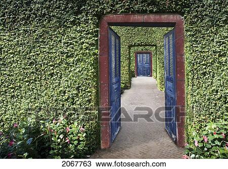 Stock Image - Composite Image Of Doors Through Hedges. Fotosearch