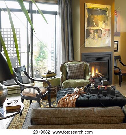 Stock Image - Condo Living Room With Fireplace Burning And Patio Doors Open, Victoria Bc.. Fotosearch