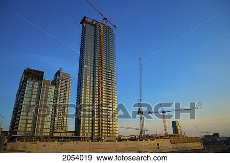 Stock Photo - Condominiums Under Construction At Sunset, Toronto, Ontario. Fotosearch