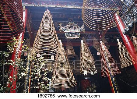 Stock Photograph - Conical Incense Coils Hanging At Temple In Ho Chi Minh City, Low Angle View. Fotosearch