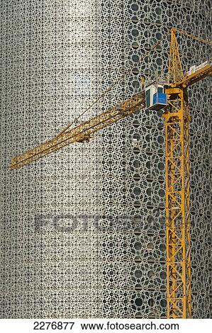 Stock Photo - Construction crane in front of new office building, Doha, Qatar.. Fotosearch