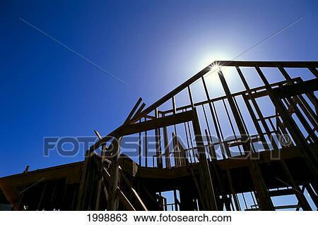 Construction House Frame With Sunburst B1176 View Large Photo Image Stock Image - Construction House Frame With Sunburst B1176. Fotosearch
