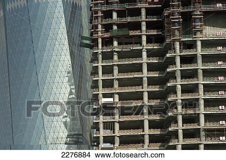 Picture - Construction site and new office building and date palm; Doha, Qatar. Fotosearch