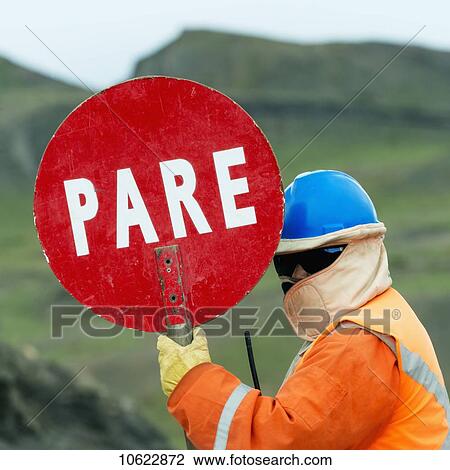 Construction worker with a stop sign in Spanish; Torres del Paine, Magallanes and Antartica Chilena Region, Chile View Large Photo Image Stock Image - Construction worker with a stop sign in Spanish; Torres del Paine, Magallanes and Antartica Chilena Region, Chile. Fotosearch