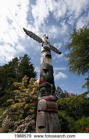 Stock Photo - Contemporary Coast Salish Totem Pole Carved By Doug Lafortune In Butchart Gardens, Victoria, British Columbia, Canada. Fotosearch