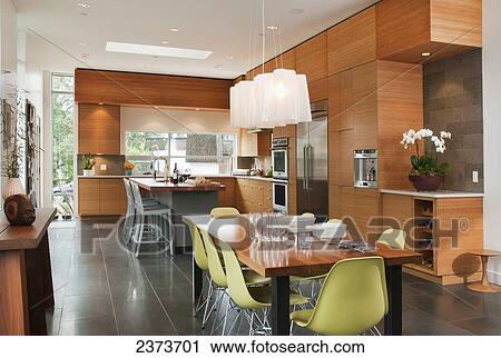 Stock Image - Contemporary Kitchen With Two Eating Areas; Victoria, Vancouver Island, British Columbia, Canada. Fotosearch