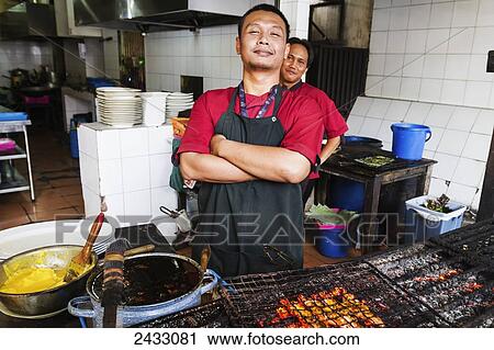 Cook barbecuing shrimp at Candi Gama Restaurant, Semarang, Central Java, Indonesia View Large Photo Image Stock Image - Cook barbecuing shrimp at Candi Gama Restaurant, Semarang, Central Java, Indonesia. Fotosearch