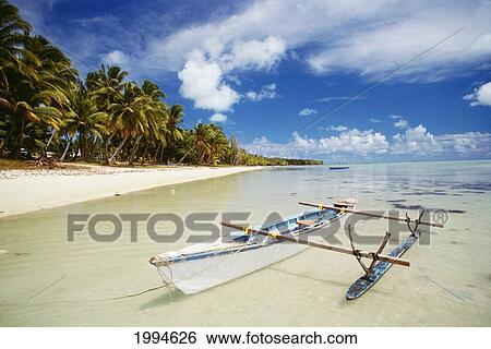 Stock Photograph - Cook Islands, Aitutaki Arutanga, Canoe In Calm Shallow Ocean, White Sand, Palm Lined Beach. Fotosearch