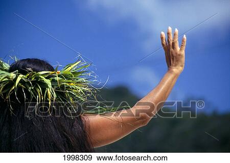 Stock Photo - Cook Islands, Back View Of Woman In Leaf Haku Lei, Hand Up, Dancing. Fotosearch