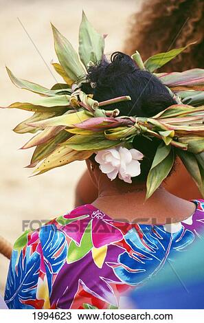 Stock Image - Cook Islands, Local Woman Wearing Haku Lei And Flower In Hair, View From Behind. Fotosearch