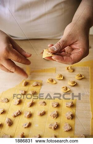 Stock Image - Cook Making Tortellini From Fresh Pasta, La Vecchia Scuola. Fotosearch