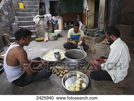 Stock Image - Cooking food on a rooftop; Hyderabad, India. Fotosearch