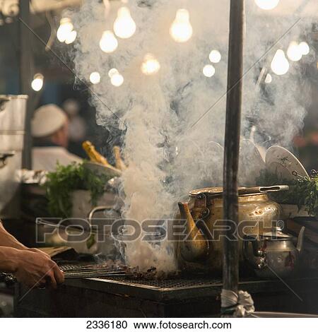 Stock Image - Cooking Over A Steaming Hot Stove; Marrakesh, Marrakech-Tensift-El Haouz, Morocco. Fotosearch