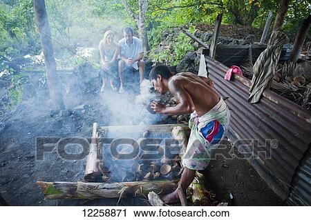 Stock Image - Cooking Sunday Umu (feast); Samoa. Fotosearch