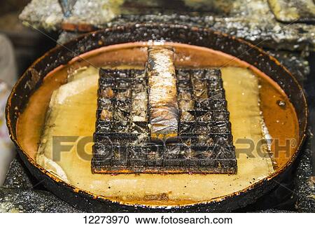 Stock Image - Copper block stamp, called cap in hot wax to be applied on a fabric in the production of printed batik at Gunawan Setiawan Batik Shop, Kampung Kauman, Surakarta (Solo), Central Java, Indonesia. Fotosearch