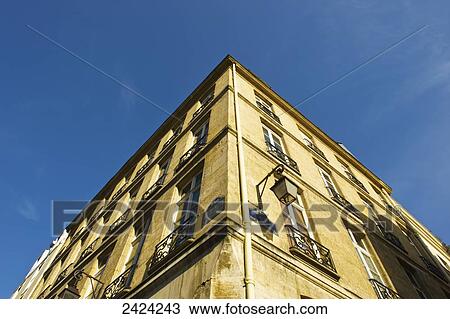 Stock Image - Corner of a building and blue sky in the historical district of the Marais; Paris, France. Fotosearch
