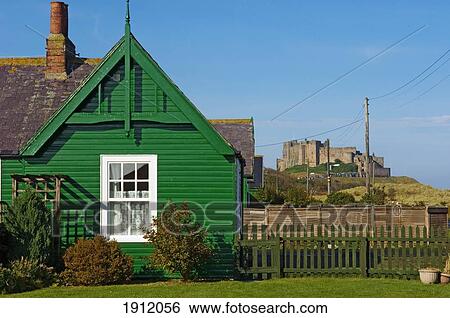 Cottage And Bamburgh Castle In Background, Bamburgh, Northumberland, England, Uk View Large Photo Image Stock Photograph - Cottage And Bamburgh Castle In Background, Bamburgh, Northumberland, England, Uk. Fotosearch