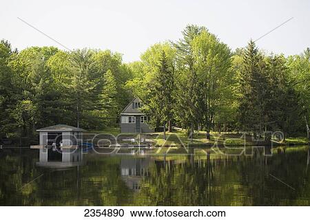 Cottage On Water Surrounded By Trees; Muskoka, Ontario, Canada View Large Photo Image Stock Image - Cottage On Water Surrounded By Trees; Muskoka, Ontario, Canada. Fotosearch