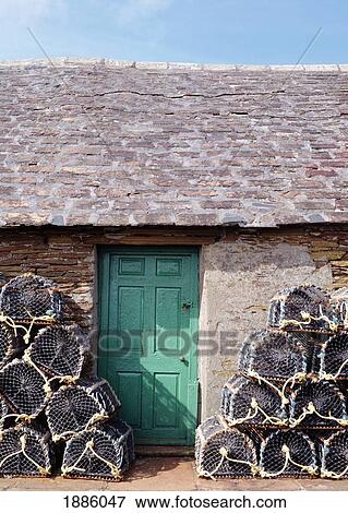 Stock Photo - Cottage With Lobster Pots Outside. Fotosearch