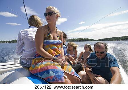 Stock Image - Cottagers In Swim Suits On A Motor Boat On Gunn Lake, Ontario, Canada.. Fotosearch