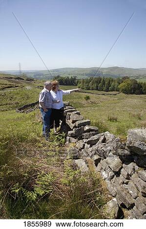Stock Photo - Couple By Rustic Stone Wall, Dumfries And Galloway, Scotland. Fotosearch