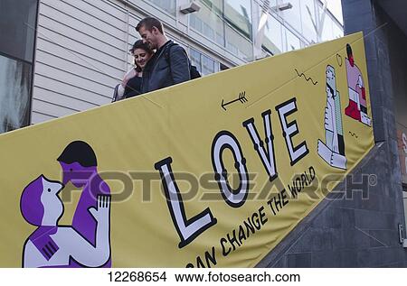 Picture - Couple descending stairs outside the Royal Festival Hall; London, England. Fotosearch