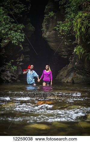 Stock Photo - Couple doing the Millennium Cave hike; Santo Island, Vanuatu. Fotosearch