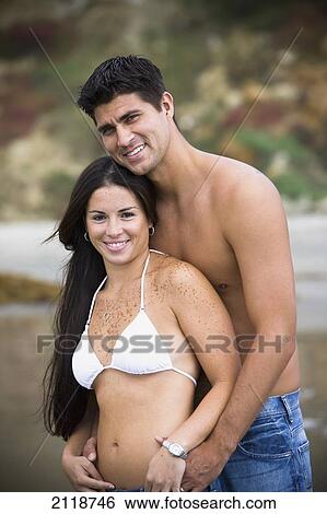 Stock Photograph - Couple Embracing On A Beach; Encinitas California Usa. Fotosearch