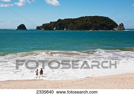 Stock Image - Couple Enjoying Holidays On Beach; New Zealand. Fotosearch
