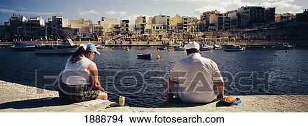 Picture - Couple Fishing By City. Fotosearch