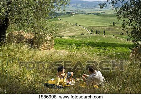 Couple Having Picnic Beside Olive Trees Looking Over The Countryside View Large Photo Image Stock Photo - Couple Having Picnic Beside Olive Trees Looking Over The Countryside. Fotosearch