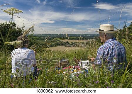 Couple Having Picnic In Meadow On The South Downs As Seen Through Wildflowers View Large Photo Image Stock Image - Couple Having Picnic In Meadow On The South Downs As Seen Through Wildflowers. Fotosearch