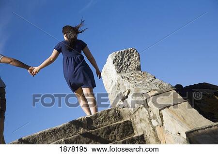 Stock Photography - Couple Holding Hands On Steps At Bondi Beach. Fotosearch