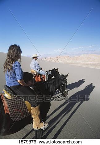 Couple Horse Riding In Valle De La Muerte View Large Photo Image Stock Photograph - Couple Horse Riding In Valle De La Muerte. Fotosearch