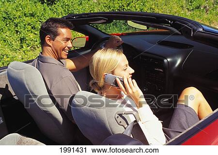 Couple In Convertible, Girl On Mobile Phone View Large Photo Image Stock Image - Couple In Convertible, Girl On Mobile Phone. Fotosearch