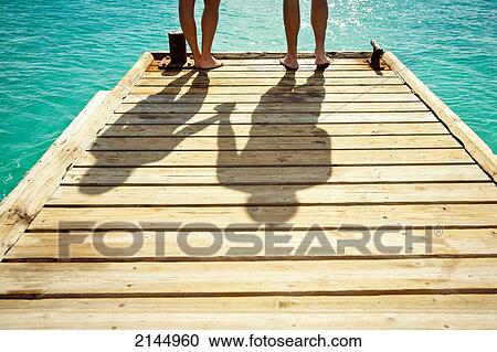 Stock Image - Couple In Cotton House Beach In Mustique Island, St Vincent And The Grenadines, West Indies. Fotosearch