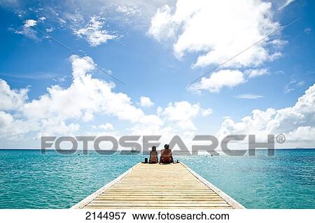 Stock Photo - Couple In Cotton House Beach In Mustique Island, St Vincent And The Grenadines, West Indies. Fotosearch