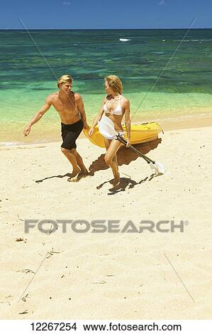 Picture - Couple kayaking; Kauai, Hawaii, United States of America. Fotosearch