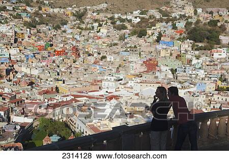 Stock Photo - Couple looking at city view; Guanajuato, Guanajuato, Mexico. Fotosearch