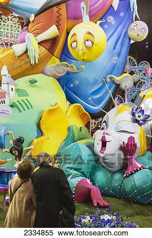 Stock Photography - Couple Looking At Large Falla Displayed On Street As Part Of Fallas Festival; Valencia, Spain. Fotosearch