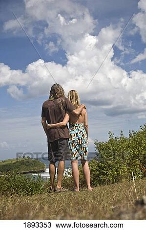 Stock Image - Couple Looking Out Over Balangan. Fotosearch