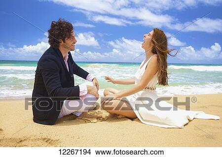 Couple on a beach; Kealia, Kauai, Hawaii, United States of America View Large Photo Image Picture - Couple on a beach; Kealia, Kauai, Hawaii, United States of America. Fotosearch