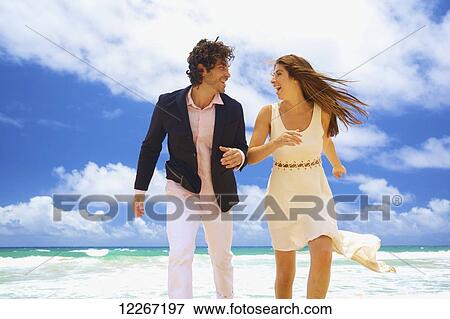 Couple on a beach; Kealia, Kauai, Hawaii, United States of America View Large Photo Image Stock Photo - Couple on a beach; Kealia, Kauai, Hawaii, United States of America. Fotosearch
