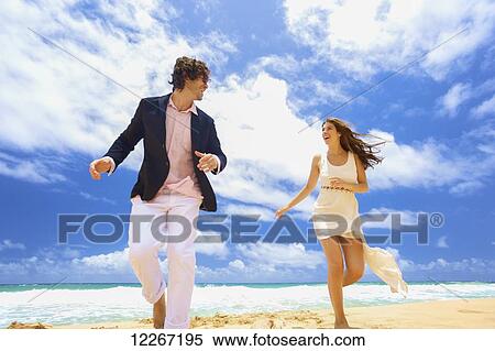 Couple on a beach; Kealia, Kauai, Hawaii, United States of America View Large Photo Image Stock Photography - Couple on a beach; Kealia, Kauai, Hawaii, United States of America. Fotosearch