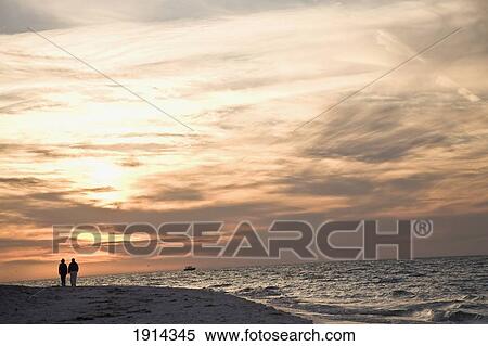 Stock Photography - Couple On Bean Point Beach At Sunset. Fotosearch