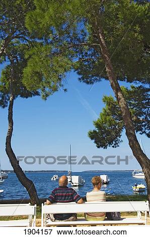 Stock Photo - Couple On Bench In Fazyana, Croatia. Fotosearch